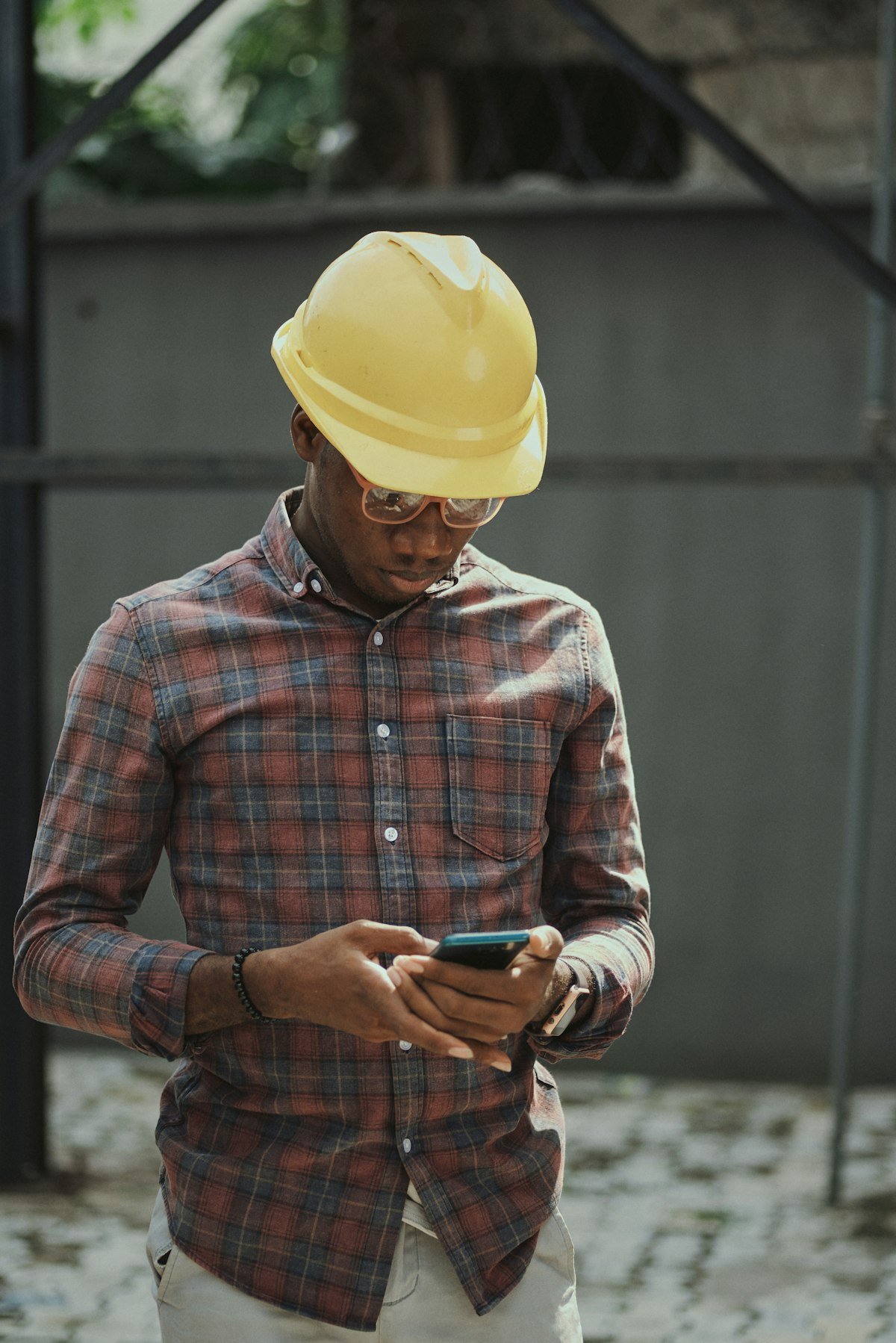Artisan plombier dans un van de chantier consultant son téléphone pour vérifier ses demandes de devis Google Ads